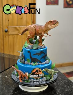 a dinosaur themed cake on top of a table