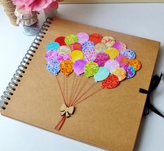 a notebook with a bunch of balloons on it