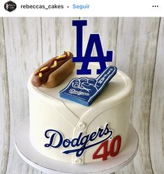 a birthday cake for a dodgers fan with a hot dog and baseball bat on top