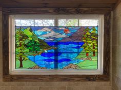 a stained glass window in the corner of a bathroom