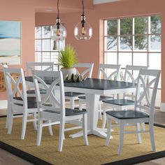 a dining room table with chairs and a rug