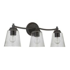 three light bathroom fixture with clear glass shades on an old - fashioned black finish wall