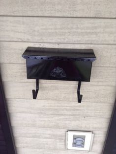 a wall mounted shelf on the side of a building