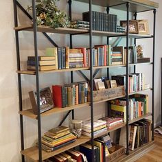 a bookshelf filled with lots of books on top of wooden shelves