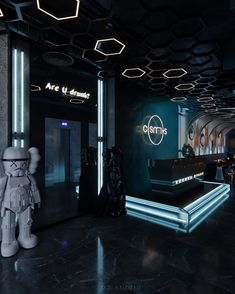 the entrance to an office building with neon lights and a robot statue in front of it