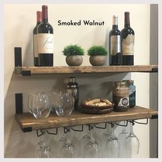 wine glasses and bottles are sitting on shelves