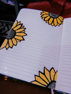 an open notebook with sunflowers painted on it