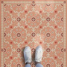 a person standing on top of a rug with their feet propped up against the floor