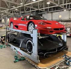 a red car is being transported on a truck