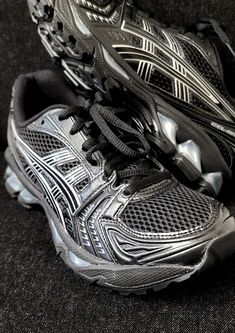 a pair of black and silver running shoes