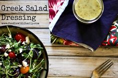 greek salad dressing in a bowl next to a fork and napkin