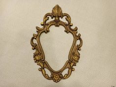 an ornate gold frame on a white background