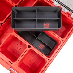 two red trays filled with different compartments and dividers on top of each other