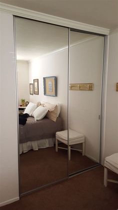 an image of a bedroom with mirrored closet doors