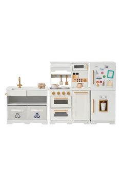 a toy kitchen with white cabinets and appliances