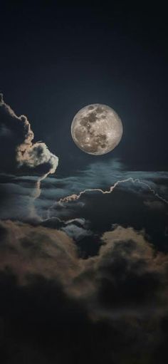 the full moon is seen through some clouds