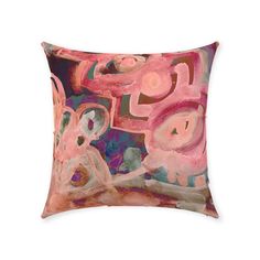 a pink and blue pillow with abstract designs on it