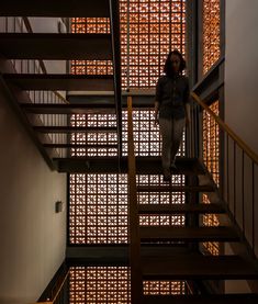 a woman standing on top of a stair case