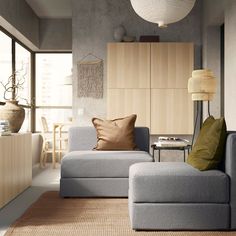 a living room with green couches and pillows