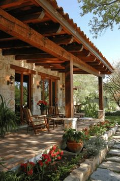 an outdoor covered patio with chairs and flowers