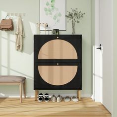 a black cabinet with two doors and some shoes on the floor in front of it