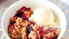 a bowl filled with fruit and ice cream next to oatmeal on a table