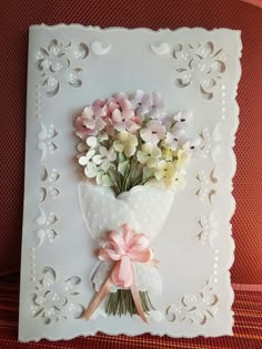 a bouquet of flowers on a white card