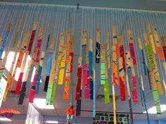 colorful wind chimes hanging from the ceiling in a room