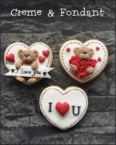 three decorated cookies in the shape of hearts with teddy bears and roses on them that say i love you