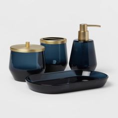 three pieces of blue and gold bathroom accessories