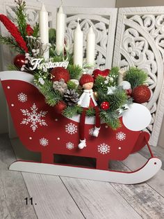 a red sleigh filled with christmas decorations and candles