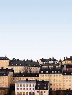 an airplane flying over some buildings in the sky with no one on it's roof