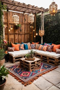 an outdoor seating area with wooden pallets, pillows and rugs on the ground