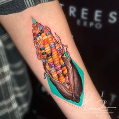 a colorful corn tattoo on the arm