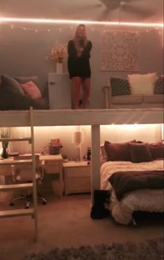 a woman standing on top of a loft bed