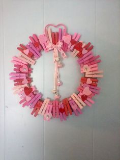 a peace sign made out of popsicle sticks and other items hanging on the wall