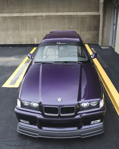 a purple car parked in a parking space