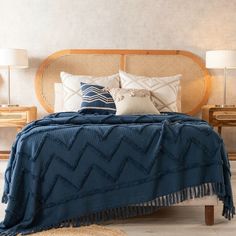 a bed with blue blankets and pillows on it