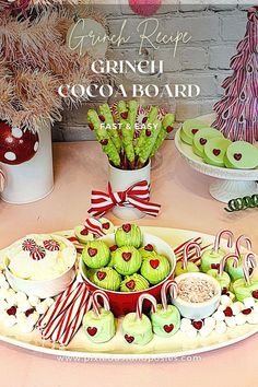 an assortment of green and red desserts on a platter with candy canes