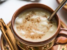 there is a cup of coffee with cinnamon sticks in it