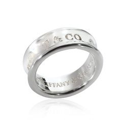 a wedding ring with the words tiffany and co engraved on it's outside side