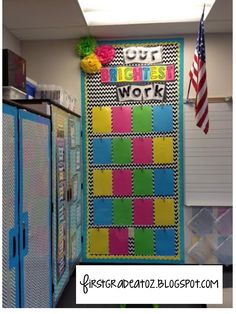 a colorful bulletin board in the middle of a room with an american flag hanging on it