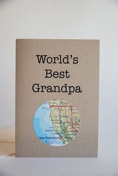 a brown card with the words world's best grandpa on it and a map