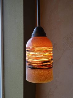 a light fixture hanging from the side of a wall