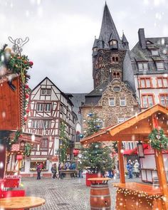 an old town square with christmas decorations on the trees