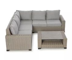 a wicker couch and coffee table set with grey cushions on an isolated white background