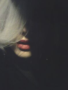 a woman with white hair and red lips