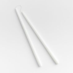 two white toothbrushes sitting next to each other on top of a white surface