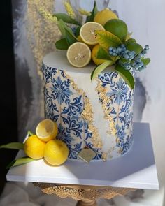 a blue and white cake with lemons on top