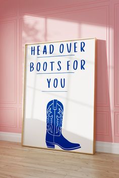 a sign that says head over boots for you in front of a pink wall and wooden floor